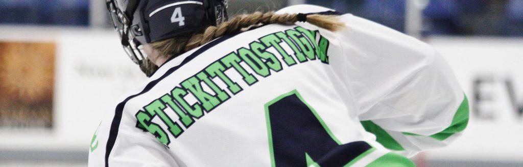Photo of UNH Women's Hockey player wearing a jersey that reads "Stick it to Stigma."